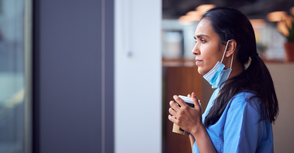 Photo of nurse holding coffee cup