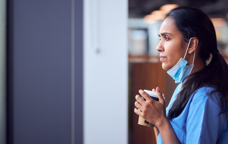 Photo of nurse holding coffee cup