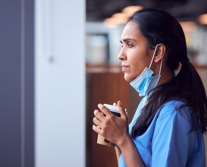 Photo of nurse holding coffee cup