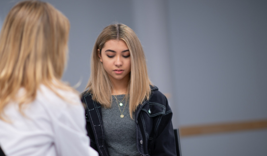 adolescent girl talking to a healthcare worker
