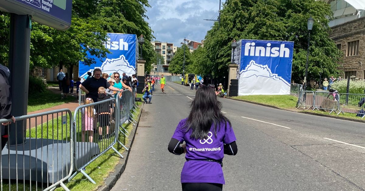 NHS Lothian Charity runner approaching the finishing line at EMF