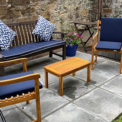 Outdoor staff wellbeing space with benches and cushions