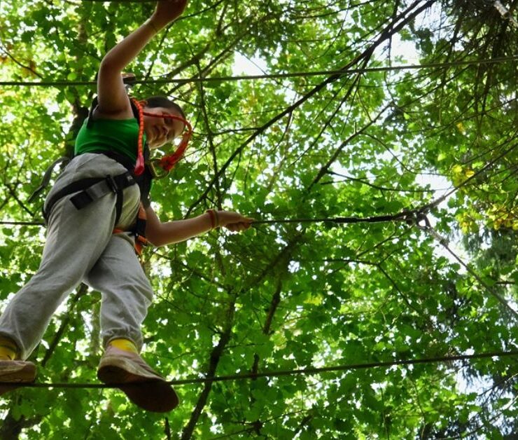 a young person on an aeriel rope course