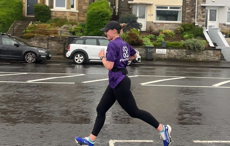 Fiona Matheson running on the road past houses in the Edinburgh Marathon Festival