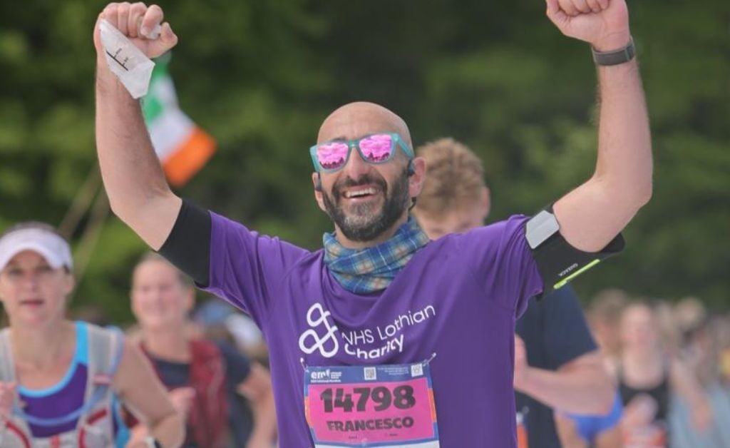 An EMF participant, Francesco Pomponi running with his arms raised in celebration