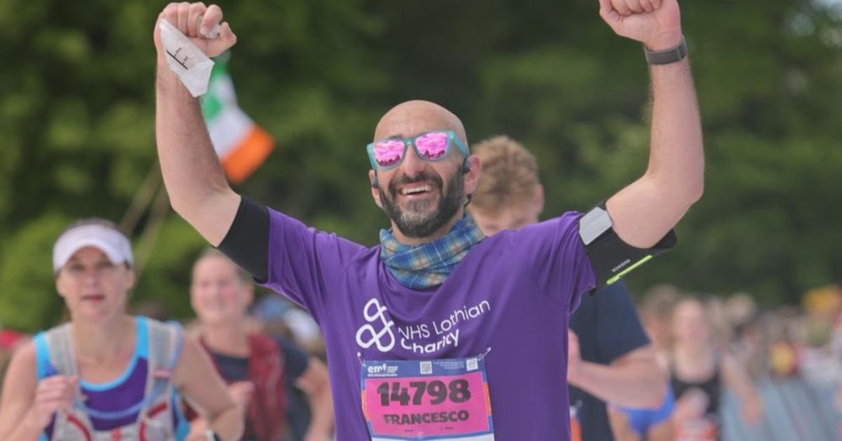 An EMF participant, Francesco Pomponi running with his arms raised in celebration