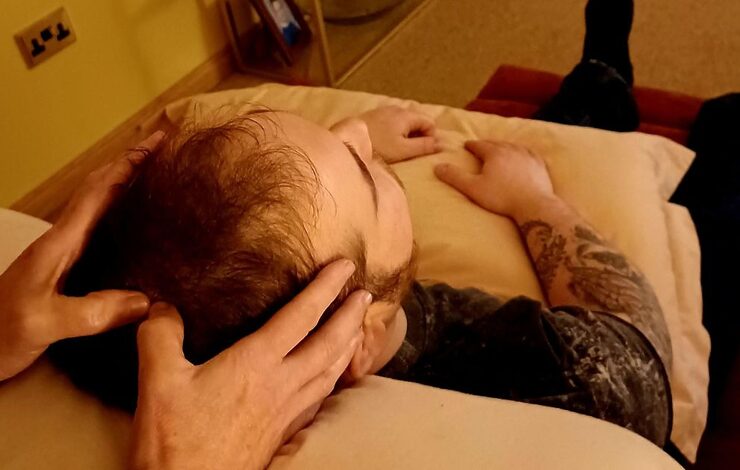a person receiving a head massage