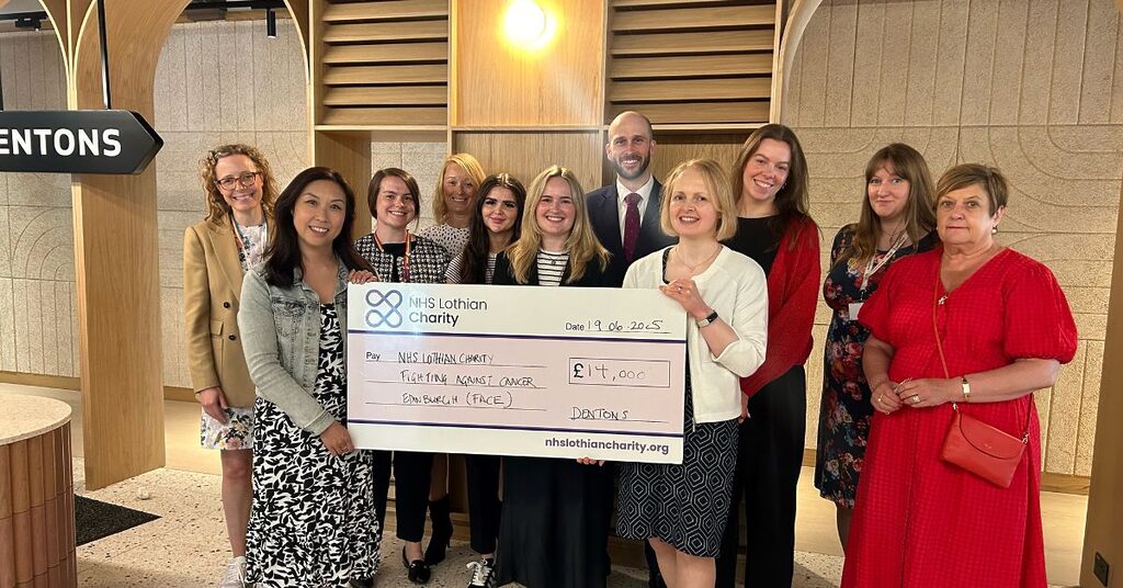 staff from Dentons presenting a cheque for £14,000 to NHS Lothian Charity