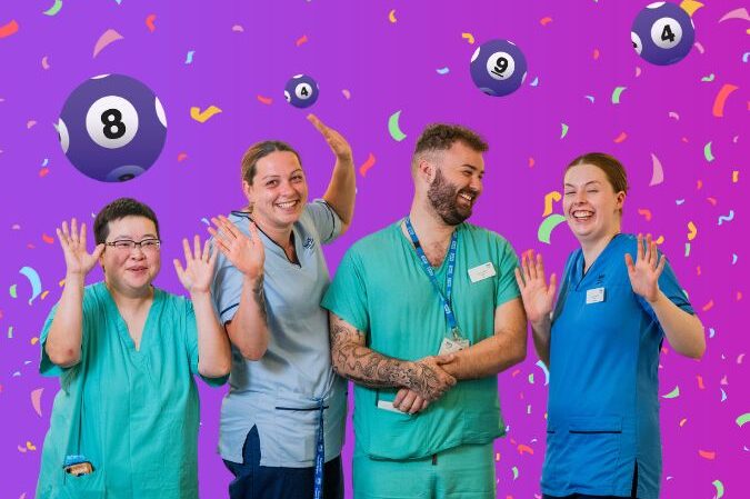 NHS Lothian staff members cheering in front of confetti and lottery balls.